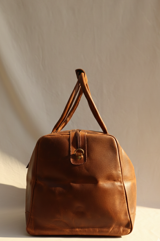 Brown leather bag on a light beige background